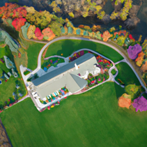 Aerial view of a wedding venue surrounded by colorful gardens and trees.