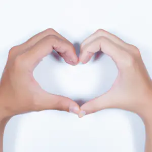 Two hands clasped together in a heart shape.