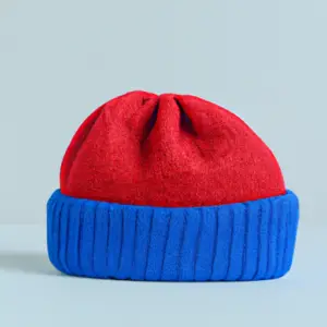 Suggestion: A bright red and blue beanie against a light gray background.