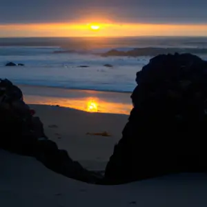 A beach sunset with a heart-shaped rock formation in the foreground.