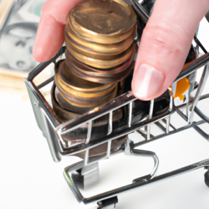 A hand holding a stack of coins and bills with a shopping cart in the background.