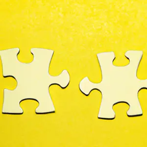A bright yellow background with two interlocking puzzle pieces.